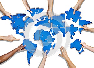 Group of Hands Holding Jigsaw Puzzle Forming World photo