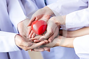 Group of hands holding a red heart. Hand of doctors. donate and insurance