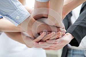 Group of hands together of young businesspeople. Stack of coordination hands Success Teamwork under viwe photo