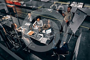 A group of handsome business people working in a spacious conference room in a large business center. Concept of startup, projects photo