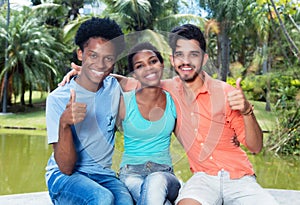 Group of happy african american and latin man and woman showing thumb