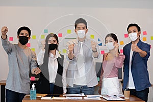 Group of Happy Asian business men leader standing smile celebrating confidence with Business team at Co-Working space