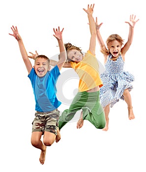 Group of happy barefeet cheerful sportive children jumping and dancing photo