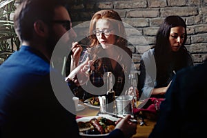 Group of happy business people eating in restaurant