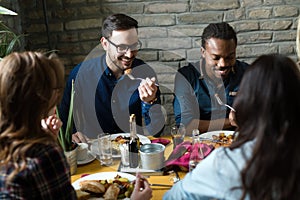 Group of happy business people eating in restaurant