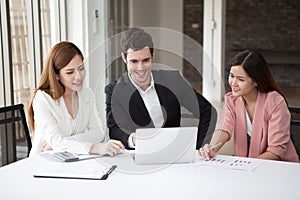 Group of happy business people men and woman working together on laptop in meeting room.teamwork of two girl asian and caucasian