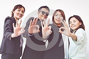 Group of happy business people showing ok gesture