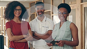 a group of happy businesspeople standing in their workplace