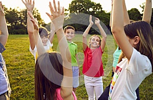 Group of happy, cheerful children playing in the park and having fun all together