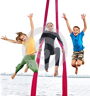 Group of happy cheerful sportive children jumping and dancing