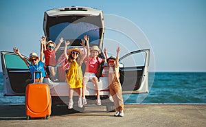 Group happy children girls and boys friends   on   car ride to summer trip