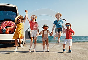 Group happy children girls and boys friends   on   car ride to summer trip