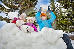 Group of happy children hold snowballs to play