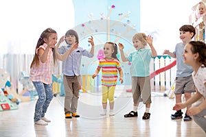 Group of happy children jump in club. Kids playing together