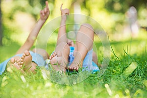 Group of happy children lying on green grass