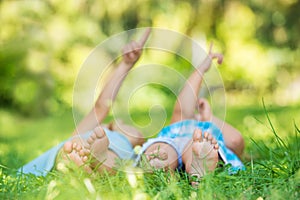 Group of happy children lying on green grass