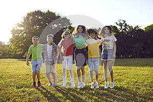 Group of happy children playing, jumping, enjoying summer, and having fun together