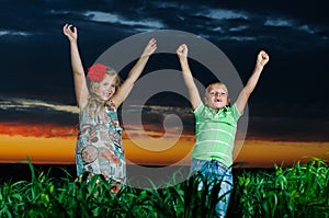 Group of happy children playing on meadow