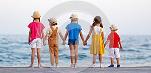Group of happy children   by   sea in summer