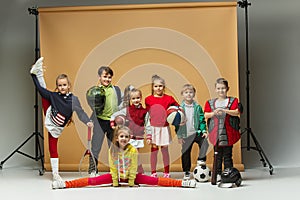 Group of happy children show different sport. Studio fashion concept. Emotions concept.