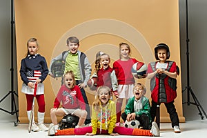 Group of happy children show different sport. Studio fashion concept. Emotions concept.