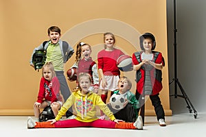 Group of happy children show different sport. Studio fashion concept. Emotions concept.