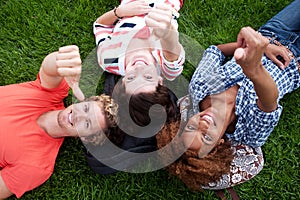 Group of happy college students in grass