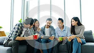 Group of happy creative team discussinng while taking coffee break at office