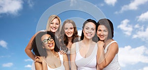 Group of happy different women in white underwear