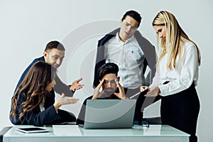 Group of happy diverse male and female business people in formal gathered around laptop computer in office