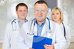 Group of happy doctors looking at camera.