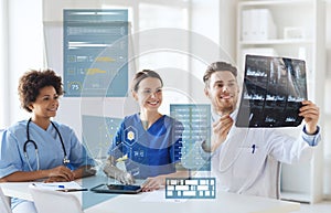 Group of happy doctors looking at x-ray image