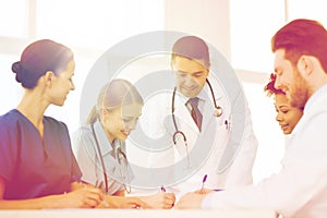 Group of happy doctors meeting at hospital office