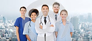 Group of happy doctors over blue background