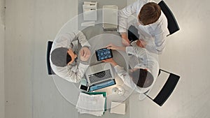 Group of happy doctors with tablet pc computers meeting at medical office. Top view