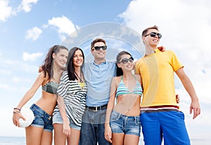 Group of happy friends with beach ball