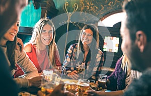 Group of happy friends drinking beer at brewery bar restaurant