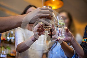 Group of happy friends drinking beer at brewery bar restaurant - Friendship concept with young people having fun together at cool