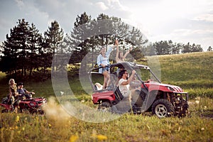 Group of happy friends driving quads together photo