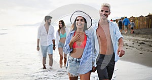 Group happy friends enjoying beach, summer vacation together