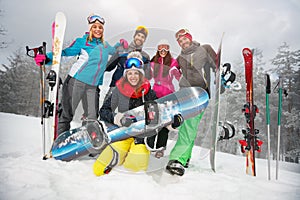 Group of happy friends having fun. Snowbarders and skiers group