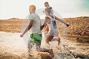 Group of happy friends having fun on summer beach