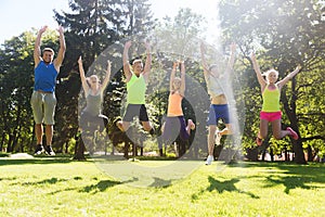 Group of happy friends jumping high outdoors photo