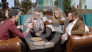 Group of happy friends making a toast with coffee at cafe