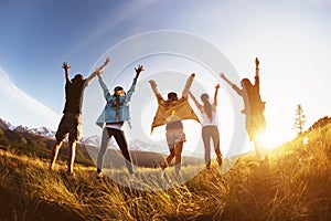 Group happy friends mountains sunset raised arms photo