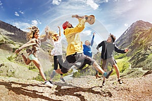 Group of happy friends music jumps trekking fun