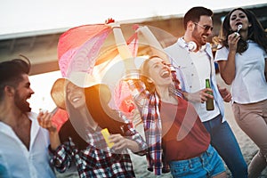 Group of happy friends partying on beach