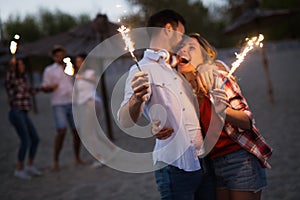 Group of happy friends partying on beach