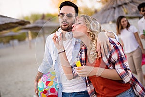 Group of happy friends partying on beach