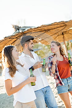 Group of happy friends partying on beach